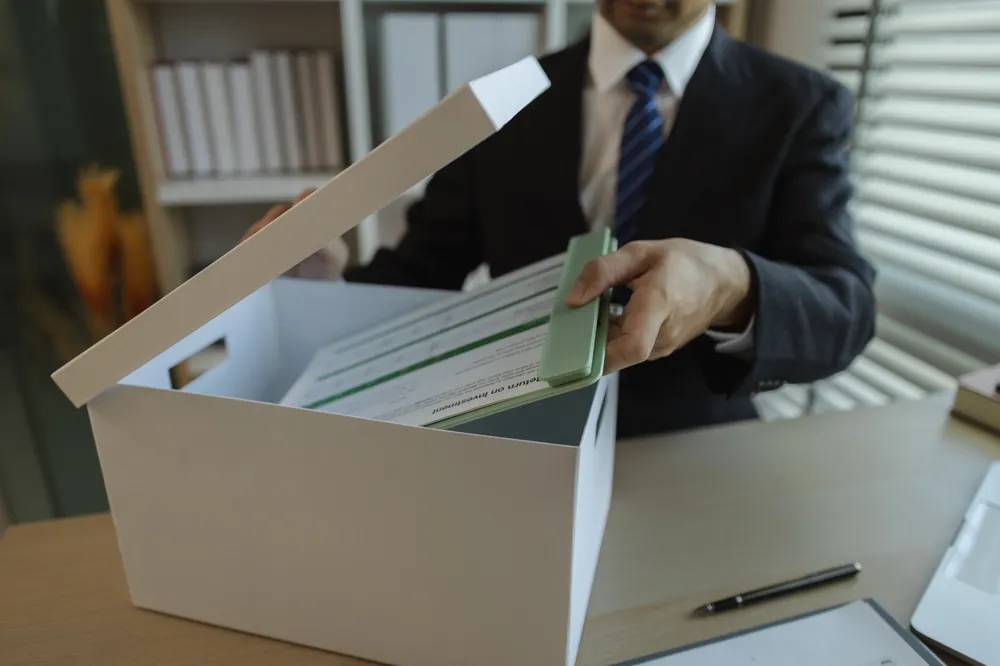Person putting documents in box